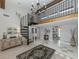 Bright entryway with high ceilings, spiral staircase, and tiled floors at 1141 Sleepy Hollow Ct, Venice, FL 34285