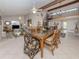 Spacious dining area with glass-top table and view into living room at 1141 Sleepy Hollow Ct, Venice, FL 34285