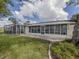 Large backyard with screened patio and lush landscaping at 1141 Sleepy Hollow Ct, Venice, FL 34285