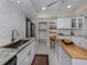 Updated kitchen with granite countertops, white cabinets, and breakfast bar at 1141 Sleepy Hollow Ct, Venice, FL 34285