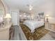 Spacious main bedroom with a large bed and sitting area at 1141 Sleepy Hollow Ct, Venice, FL 34285