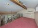 Spacious loft area with carpeted floors and built-in shelving at 1141 Sleepy Hollow Ct, Venice, FL 34285
