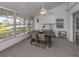 Bright sunroom with water views, table and chairs, creating a relaxing space at 1141 Sleepy Hollow Ct, Venice, FL 34285