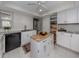 Bright kitchen with white cabinets, granite counters, and island at 1141 Sleepy Hollow Ct, Venice, FL 34285
