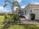 Single-story home with gray siding, brick walkway, and lush landscaping at 127 Sevilla Pl, North Venice, FL 34275