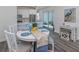 Bright dining area with round table and colorful runner at 128 Clifton Way, Venice, FL 34292