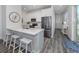 Modern kitchen with white cabinets and a breakfast bar at 132 Clifton Way, Venice, FL 34292