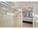 Bathroom with glass shower enclosure and view of bedroom at 13800 Rinuccio St, Venice, FL 34293