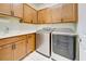 Convenient laundry room with ample cabinetry and modern appliances at 13873 Rinuccio St, Venice, FL 34293