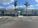 Exterior of clubhouse with blue trim, tile roof, and handicap parking at 139 Ibiza Loop, Venice, FL 34292