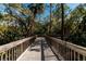 Wooden boardwalk path meandering through a verdant, natural landscape at 150 Bella Vista Ter # 15B, Nokomis, FL 34275