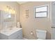 Clean bathroom with vanity, toilet, and shower at 1743 Lake Pl # 1743C, Venice, FL 34293
