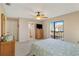 Bedroom with a queen bed, wicker furniture, and en-suite bathroom at 1743 Lake Pl # 1743C, Venice, FL 34293