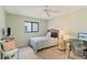Guest bedroom with a bed, desk, chair, and closet at 1743 Lake Pl # 1743C, Venice, FL 34293