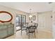 Dining area with glass table and wicker chairs near a patio at 1743 Lake Pl # 1743C, Venice, FL 34293