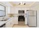 Kitchen with white cabinets, stainless steel appliances, and gray countertops at 1743 Lake Pl # 1743C, Venice, FL 34293