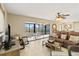 Living room with brown leather sofas and access to a patio with water view at 1743 Lake Pl # 1743C, Venice, FL 34293
