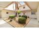 Private courtyard with landscaping and a central palm tree at 1743 Lake Pl # 1743C, Venice, FL 34293