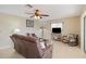 Living room with brown leather sectional and rocking chair near balcony at 1743 Lake Pl # 1743C, Venice, FL 34293