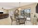 Dining area with glass table and wicker chairs, overlooking a patio at 1743 Lake Pl # 1743C, Venice, FL 34293