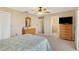 Bright bedroom with a comfy bed, dresser, and ceiling fan at 1743 Lake Pl # 1743C, Venice, FL 34293