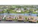Aerial view of waterfront community with multiple buildings, parking, and canal at 1743 Lake Pl # 1743C, Venice, FL 34293
