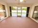 Enclosed patio with view of backyard through screened windows at 18194 Driggers Ave, Port Charlotte, FL 33948