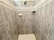 Shower stall with gray tile and white accents at 18194 Driggers Ave, Port Charlotte, FL 33948