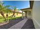 Brick walkway leading to the house entrance with palm trees and landscaping at 19140 Mangieri St, Venice, FL 34293