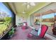 Bright screened porch with brick pavers, comfy seating, and sliding glass doors at 19313 Yellowtail Ct, Venice, FL 34292