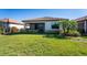 Spacious backyard with lush grass and screened patio at 24057 Spartina Dr, Venice, FL 34293