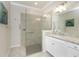 Elegant bathroom featuring a walk-in shower and granite countertop at 24057 Spartina Dr, Venice, FL 34293