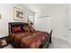 Bedroom with dark wood furniture and patterned bedding at 24057 Spartina Dr, Venice, FL 34293