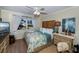 King-size bed and dresser in a bedroom with large windows at 250 Santa Maria St # 118, Venice, FL 34285