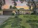 Single-story home with brown garage door at 2512 Regatta Dr, Sarasota, FL 34231