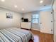 Spacious bedroom with a striped comforter, dresser, and hardwood floors at 2512 Regatta Dr, Sarasota, FL 34231