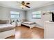 Bedroom with two twin beds, ceiling fan, and hardwood floors at 2512 Regatta Dr, Sarasota, FL 34231