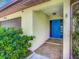 Bright blue front door with tiled entryway at 2512 Regatta Dr, Sarasota, FL 34231