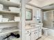 Clean bathroom with a white vanity, large mirror, and shower/tub combo at 2512 Regatta Dr, Sarasota, FL 34231