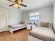 Bedroom with two twin beds, ceiling fan, and hardwood floors at 2512 Regatta Dr, Sarasota, FL 34231