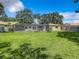 Backyard with screened pool, patio, and expansive grassy area at 2512 Regatta Dr, Sarasota, FL 34231