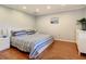 Main bedroom with a large bed, dresser, and hardwood floors at 2512 Regatta Dr, Sarasota, FL 34231