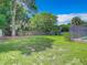 Spacious backyard with fenced area, lush lawn and screened pool at 2512 Regatta Dr, Sarasota, FL 34231
