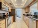Modern kitchen with stainless steel appliances and wood cabinets at 2512 Regatta Dr, Sarasota, FL 34231