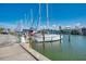 Boats docked at a marina with clear water and residential buildings nearby at 257 Teramo Way, Nokomis, FL 34275