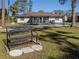 Backyard view with a metal bench and a partially visible patio at 3331 Traverse Ave, North Port, FL 34286