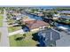Aerial view of two waterfront homes with boat lifts and lush landscaping at 3390 Dover Dr, Punta Gorda, FL 33983