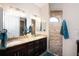Double vanity bathroom with granite countertops and walk-in shower at 3390 Dover Dr, Punta Gorda, FL 33983