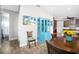 Bright dining area with round wooden table and teal accent cabinet at 3390 Dover Dr, Punta Gorda, FL 33983