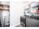 Laundry room with washer, dryer, and storage shelves at 3390 Dover Dr, Punta Gorda, FL 33983